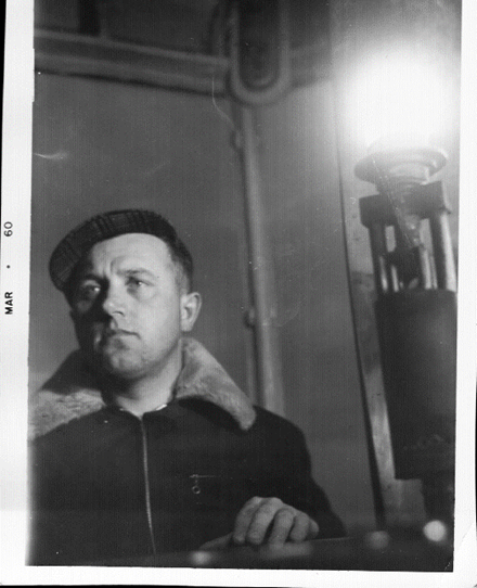 Old black and white photo (1960). Vernon Zwicker beside a bright light. 
