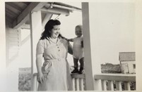 Melanie’s randmother, Ardath Crooks- Zwicker, holding up and her first born on the porch railing 