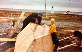 Melanie’s great uncle, Don Crooks. Don is sealing the seams of a small boat on Country Island, 1978. Lighthouse in background