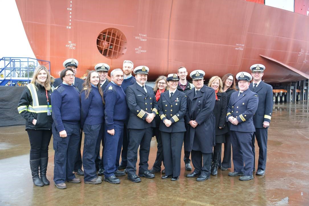 Robb Wight and colleagues, dressed in uniform, standing in front of the CCGS John Franklin