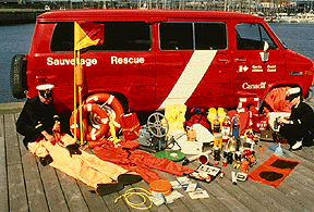 Asortment of rescue supplies presented in front of a red CCG van